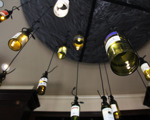 Decorative bottle lamps in Slices Pizzeria.com interior.
