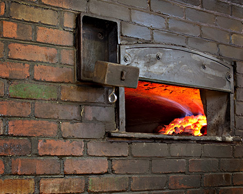 Slices Pizzeria.com brick oven access door.
